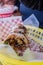 Burrito covered with sauce and seeds on a plastic basket