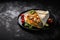Burrito wrappers with chicken and vegetables on a black plate with copy space , Generative AI