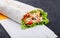 Burrito wraps from fillet grilled chicken, lettuce, slices of fresh tomatoes, pickles and cheese