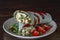 Burrito wraps with scrambled egg omelet and vegetables in green pita bread . Closeup