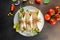 Burritos wraps with chicken, avocado, fresh tomatoes, limes on plate. Mexican dish. place for text, top view