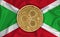 Burundi flag, ripple gold coin on flag background. The concept of blockchain, bitcoin, currency decentralization in the country.