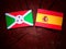 Burundi flag with Spanish flag on a tree stump