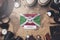 Burundi Flag Between Traveler`s Accessories on Old Vintage Map. Overhead Shot