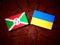 Burundi flag with Ukrainian flag on a tree stump isolated