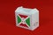 Burundi flag on white box with barcode and the color of nation flag on red background. The concept of export trading from Burundi