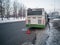 The bus broke down. The driver has a problem. Winter is on the street. A public bus driver is trying to fix a breakdown. Public