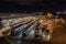 bus depot at night, with buses and other vehicles parked in the lot