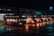 bus depot at night, with the lights shining bright and the buses parked in their slots