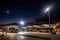 bus depot at night, with the moon shining overhead and a full view of the bus terminal