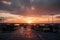 bus depot with view of sunset over the horizon, silhouetting the buses and terminals against a peaceful sky