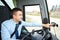 Bus driver entering address to gps navigator