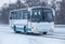 bus moves in winter along road