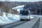 Bus moves in winter along a snow-covered winding country highway