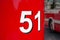 Bus number. Close-up of number 51 aboard a red old passenger bus. Retro transport