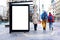 bus shelter with blank white ad billboard at busstop. blurred urban street setting with pedestrians