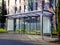 Bus shelter at a bus stop of glass and aluminum structure in park like setting