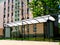 Bus shelter of glass and aluminum structure in park-like setting