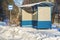 Bus shelter near snow covered road in winter