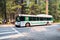 Bus shuttling tourists between various interest point located in Yosemite National Park