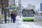 bus, standing near the bus stop and passengers