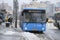 Bus, standing near the bus stop and passengers