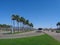 Bus stop, palm trees and green grass on the lawn