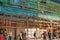 Bus stop under a building wrapped in traditional Chinese scaffolding in Hong Kong