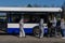 Bus workers wearing protective costumes and face protective masks waiting for passengers at arrival at Riga International Airport