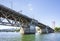 Buscle Burnside Bridge with big support columns and truss roadbed across Willamette River in Portland Oregon