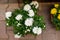 Bush of white chrysanthemums blossom in a flower pot, top view. A romantic bouquet of blooming chrysanthemums as a gift, natural