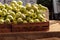 Bushel of green apples in a crate at a farmerâ€™s market