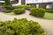 bushes and evergreen plants in stone walkway in landscape design