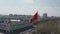 Bushkek, Kyrgyzstan - April 3, 2020: Aerial cinematic footage of red Kyrgyz national flag winding in the wind in golden