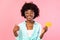 Bushy African Woman Showing Credit Card Gesturing Thumbs-Up, Pink Background