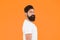 Bushy beard hipster man barbershop client orange background, confident macho concept