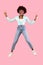 Bushy Black Millennial Woman Jumping Gesturing V-Sign, Pink Background, Vertical