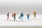 Businees miniature people running on notebook line