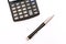 Business abstract - calculator and elegant pen.