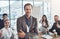 Business is all good. Portrait of a mature businessman standing in an office with his colleagues showing thumbs up in