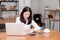 Business asian woman writing on notebook on table with laptop