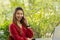 Business Asian young woman wearing red dress working smile and talking with customer in smartphone to get idea and requirement