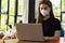 Business Asian young woman working with computer laptop and wearing protection mask be congested with virus infection