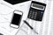 Business black and white items - smartphone, elegant pen, calculator