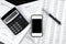 Business black and white items - smartphone, elegant pen, calculator