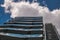 Business building with metal emergency ladder / fire escape in modern office buildings with repeating structure and reflected sky