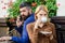 Business call white dating. First meet of girl and mature man. Brutal bearded hipster and girl drink coffee. Couple in