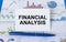 Business card with text Financial Analysis laying on financial graphs