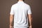 Business casual mens white polo shirt from behind, exuding relaxed professional elegance