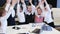 Business children in office making pile of hands